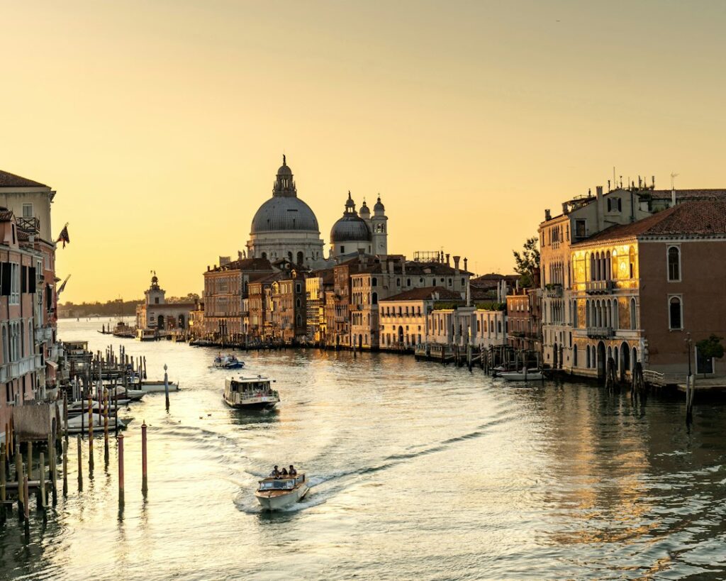Golden morning light over the Grand Canal in Venice with Santa Maria della Salute in the background — the landmark right next to Centurion Palace