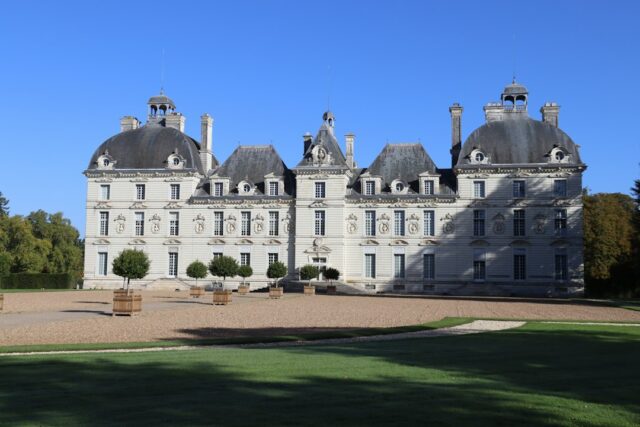 Grand French château with manicured gardens and blue sky, a classic wedding venue in the Loire Valley style